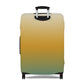 Baja Sunset gradient stretch luggage cover in golden amber and teal fitted on hard shell rolling suitcase