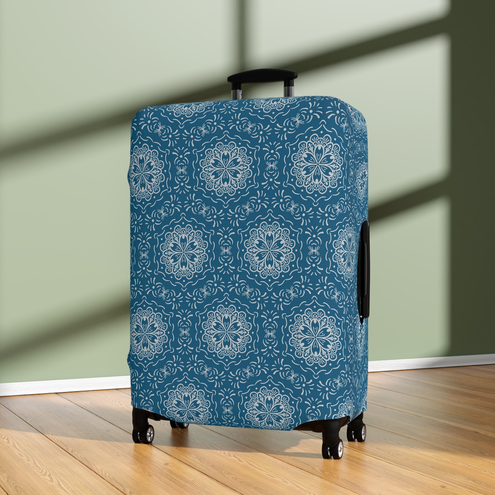 Blue BoHo stretch luggage cover with white mandala pattern fitted on rolling suitcase