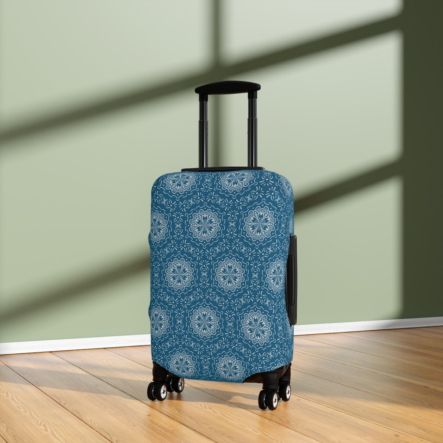 Blue BoHo stretch luggage cover with white mandala pattern fitted on rolling suitcase