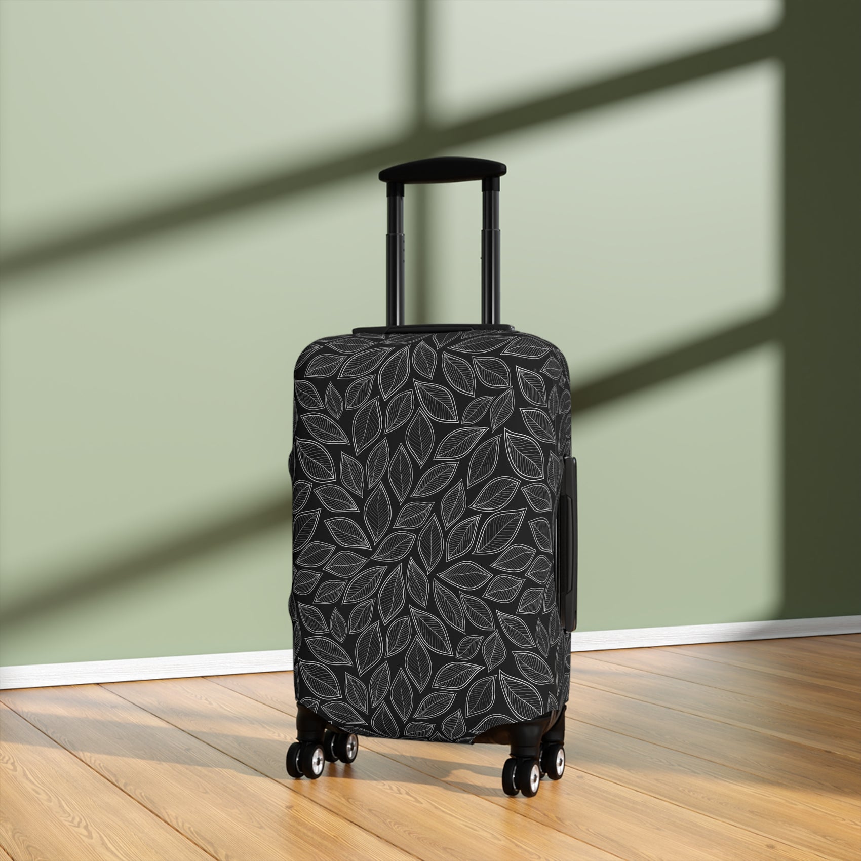 Central Park black stretch luggage cover with grey leaf pattern fitted on rolling suitcase