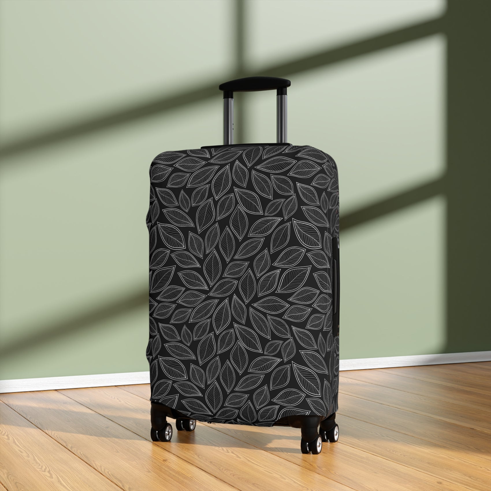 Central Park black stretch luggage cover with grey leaf pattern fitted on rolling suitcase