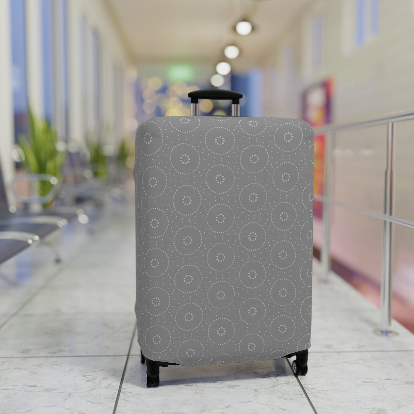 Lapland Lights gray stretch luggage cover with white circular snowflake pattern on rolling suitcase