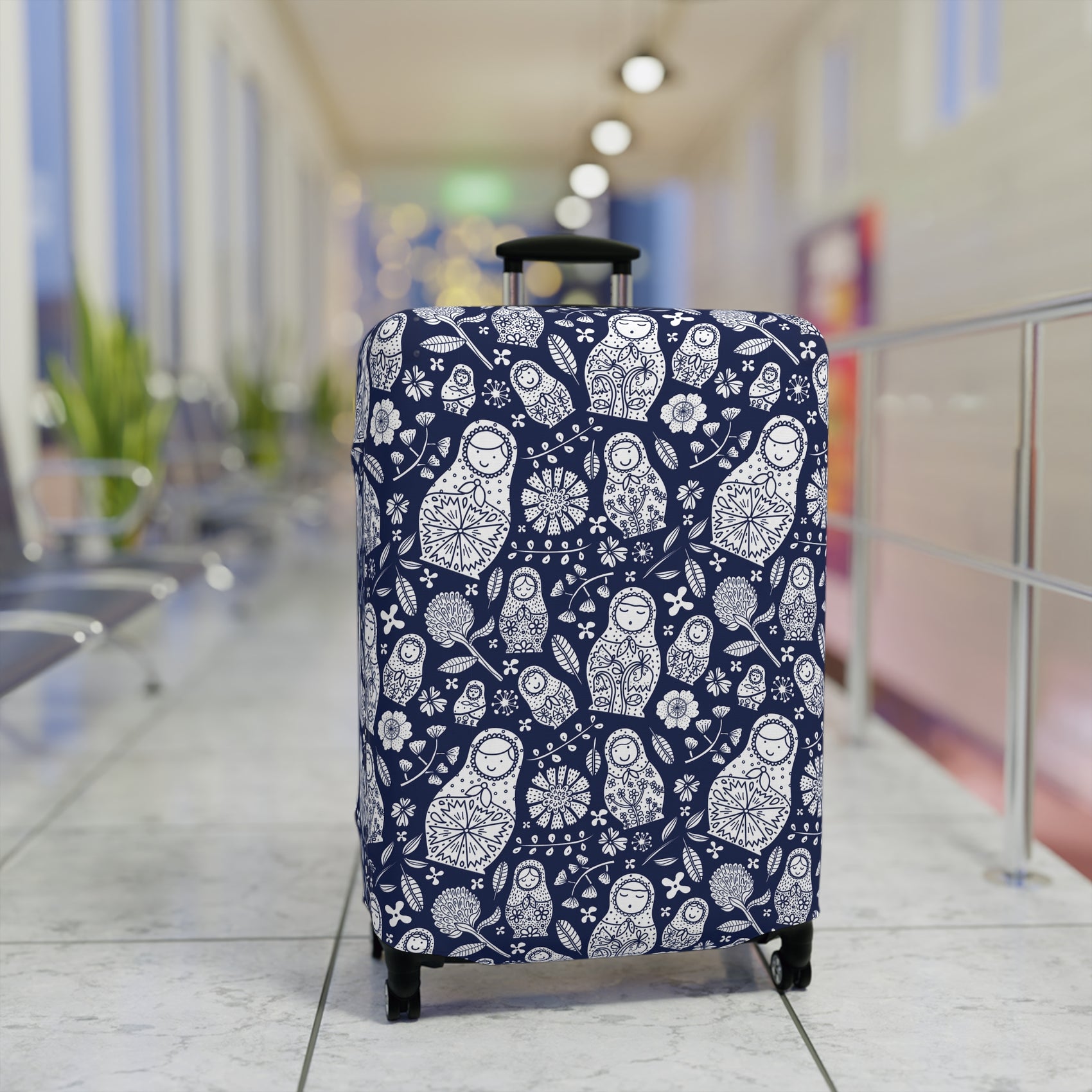 Matryoshka Blue folk art stretch luggage cover with white nesting doll pattern on deep blue background