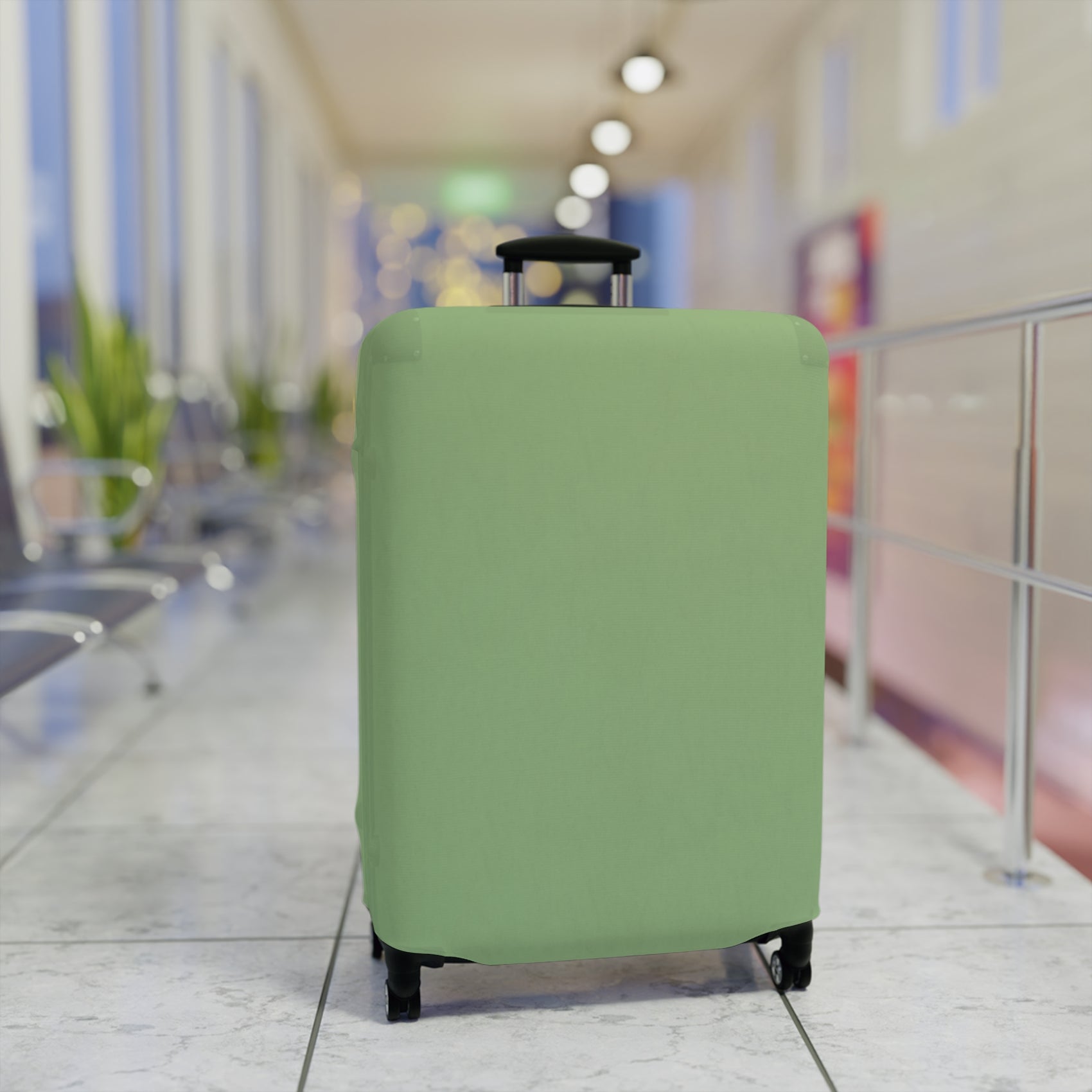 Green stretch luggage cover protecting a rolling suitcase with secure zipper closure