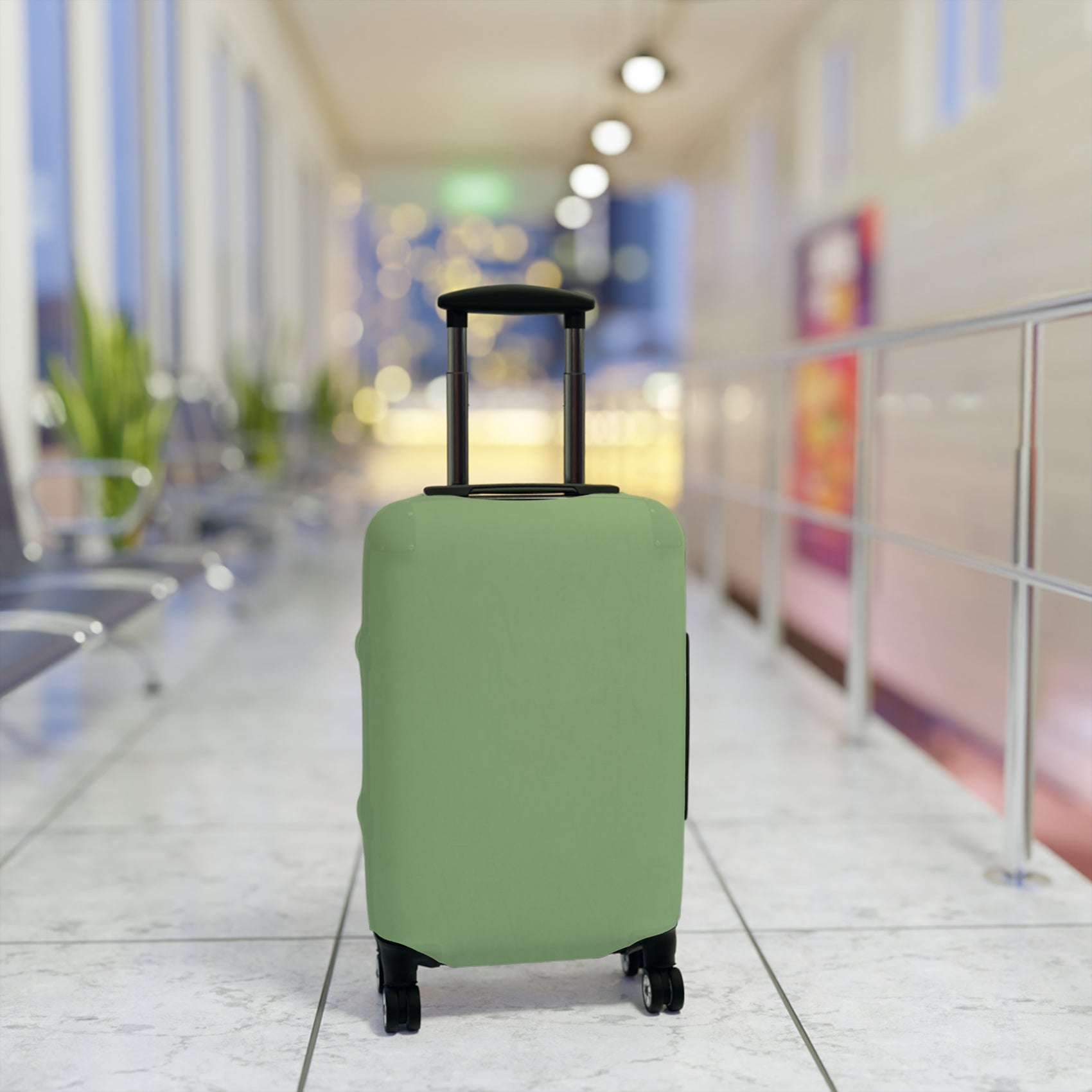 Green stretch luggage cover protecting a rolling suitcase with secure zipper closure