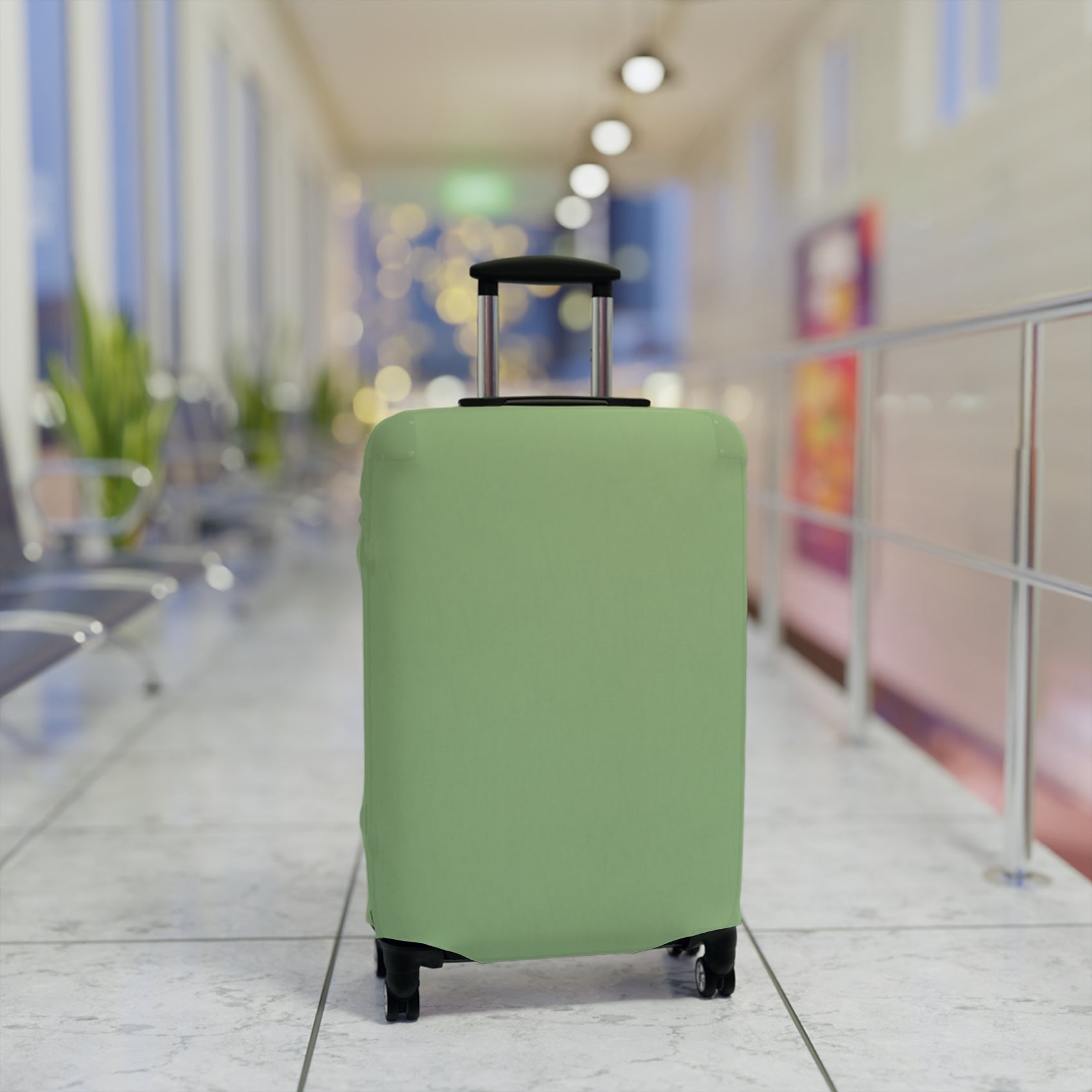 Green stretch luggage cover protecting a rolling suitcase with secure zipper closure