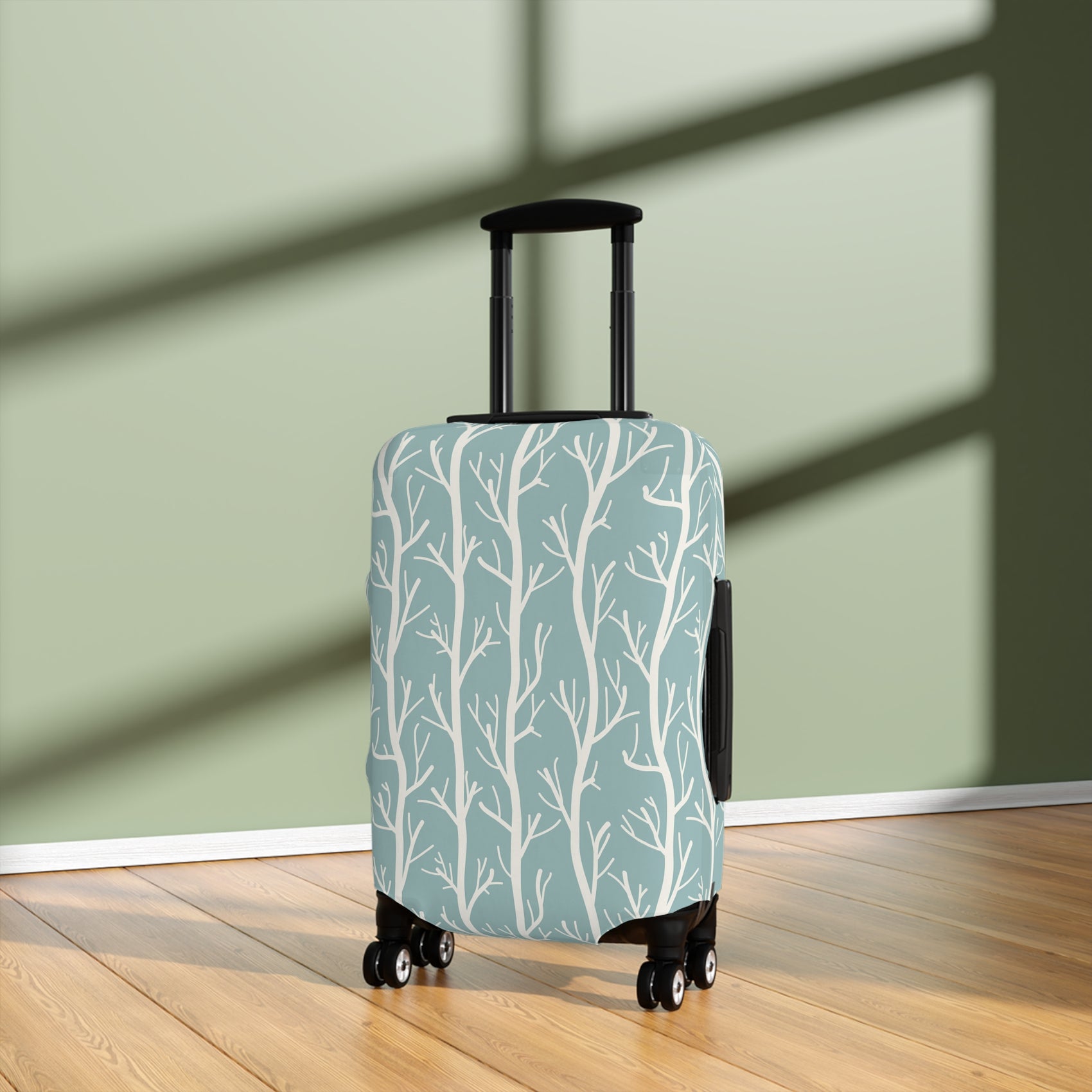 Norwegian Dusk tree pattern stretch luggage cover with white winter trees on blue green suitcase
