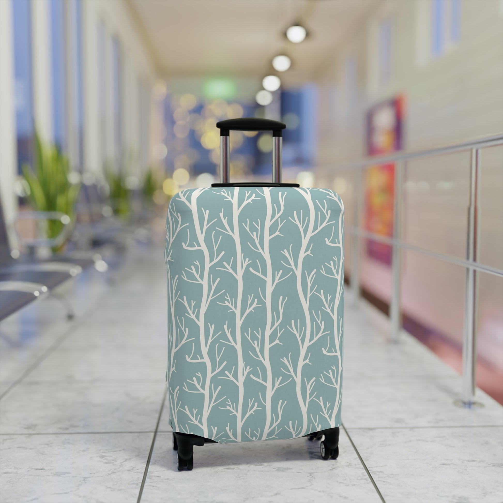 Norwegian Dusk tree pattern stretch luggage cover with white winter trees on blue green suitcase