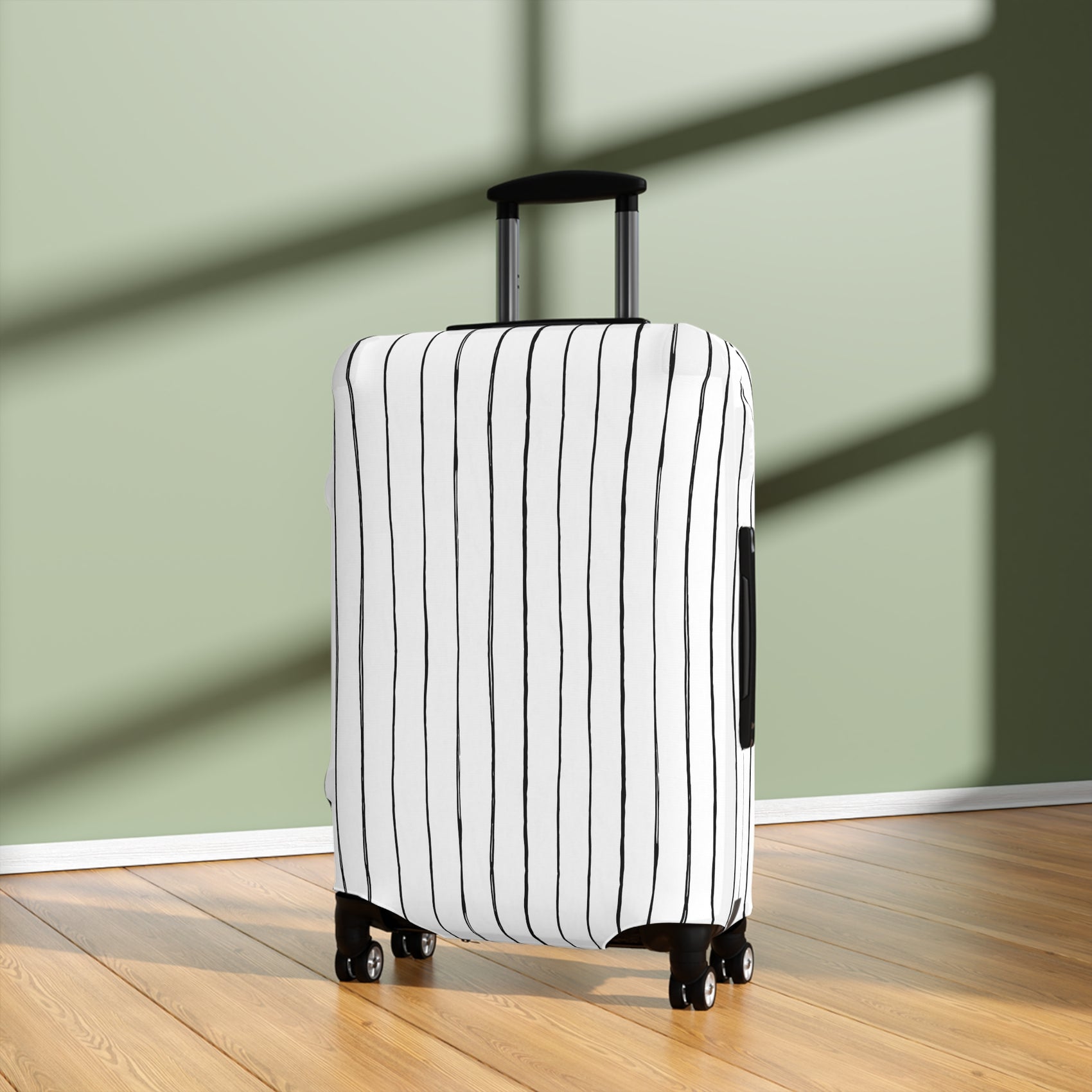 Black and white striped stretch luggage cover with zipper closure protecting a rolling suitcase