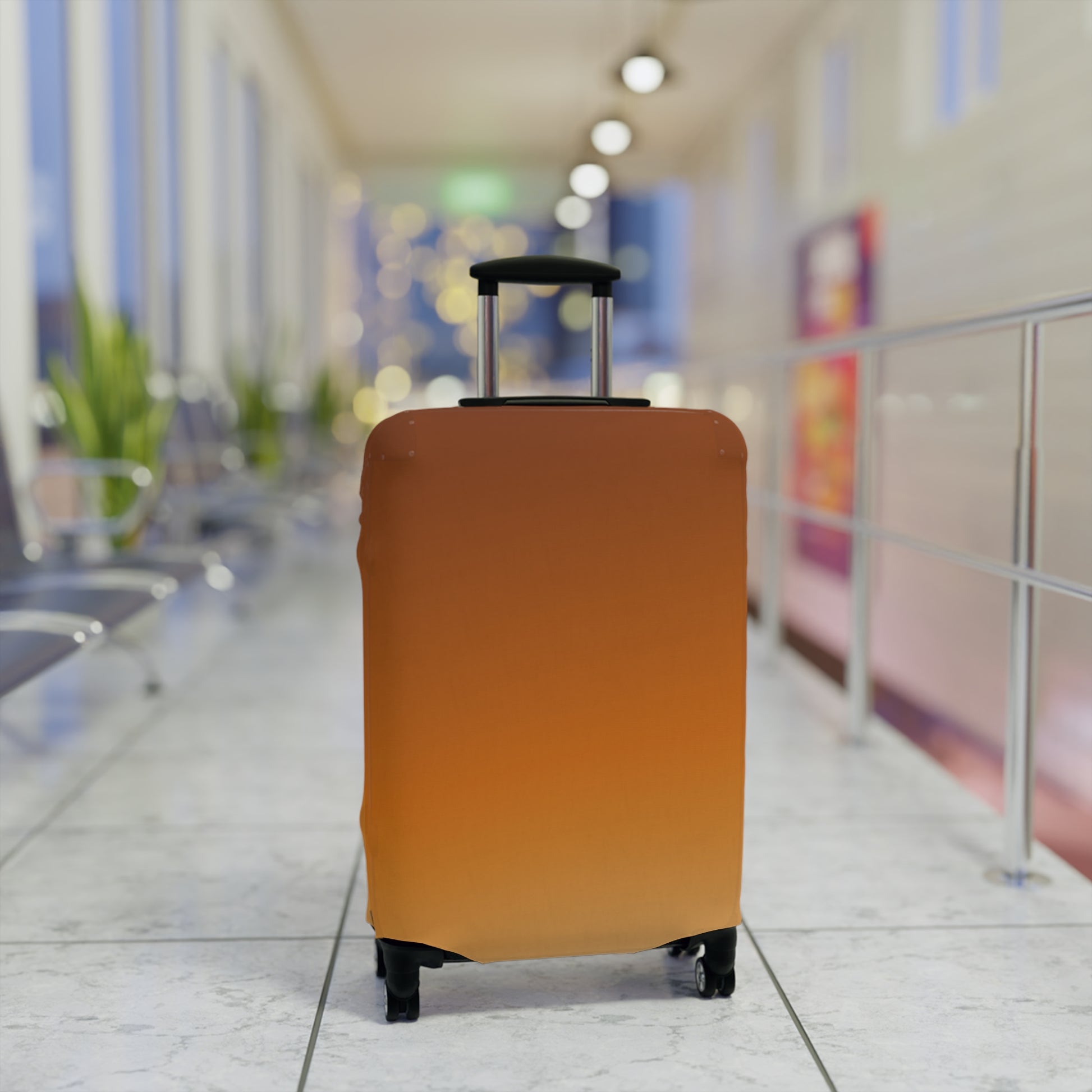 Burnt orange gradient stretch luggage cover protecting a rolling suitcase