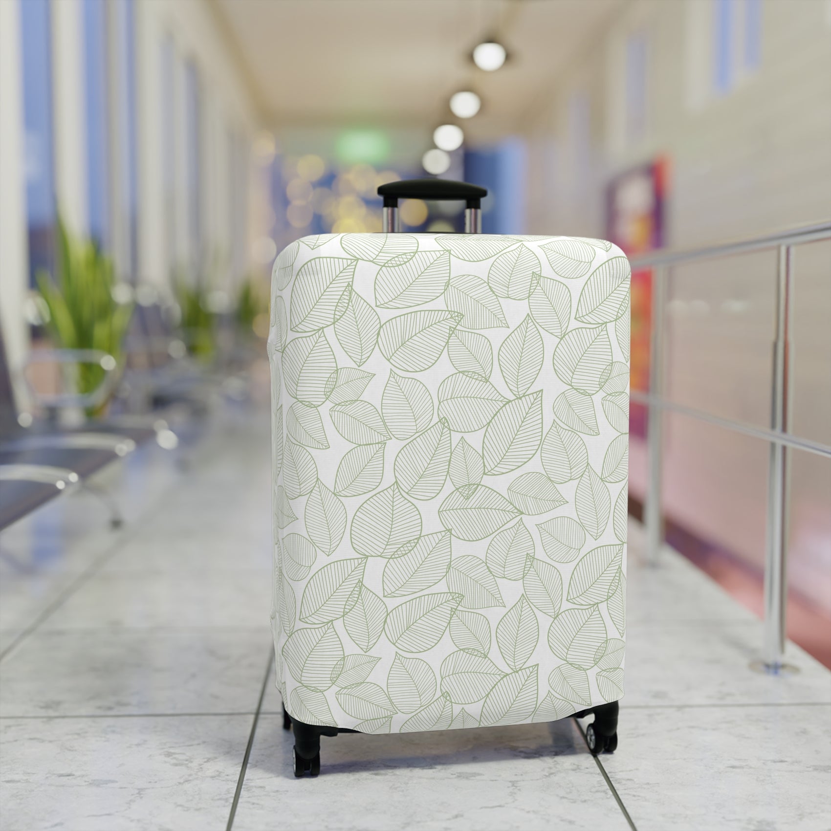 Urban Botanica stretch luggage cover with minimalist green leaf pattern on white background