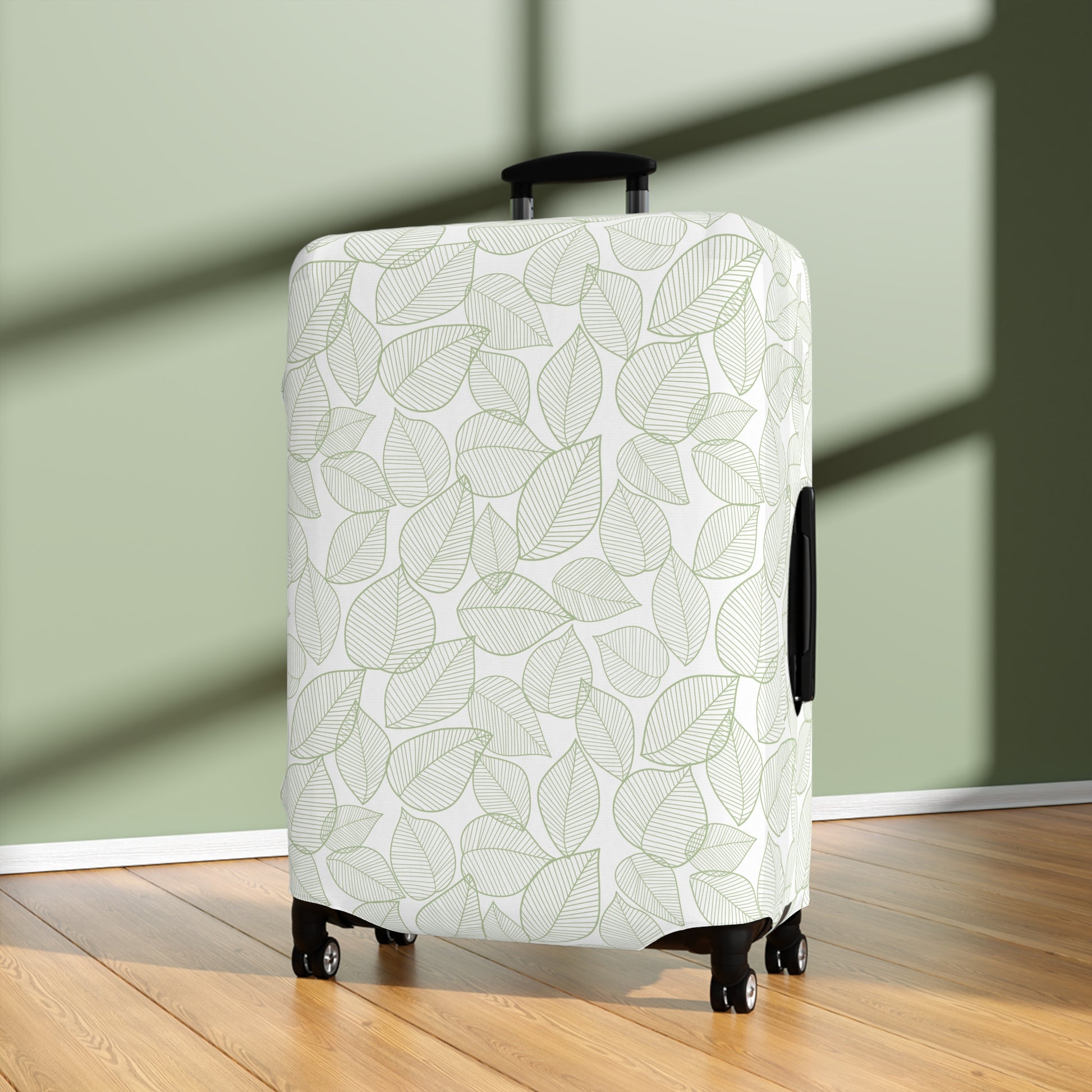 Urban Botanica stretch luggage cover with minimalist green leaf pattern on white background