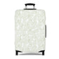 Urban Botanica stretch luggage cover with minimalist green leaf pattern on white background