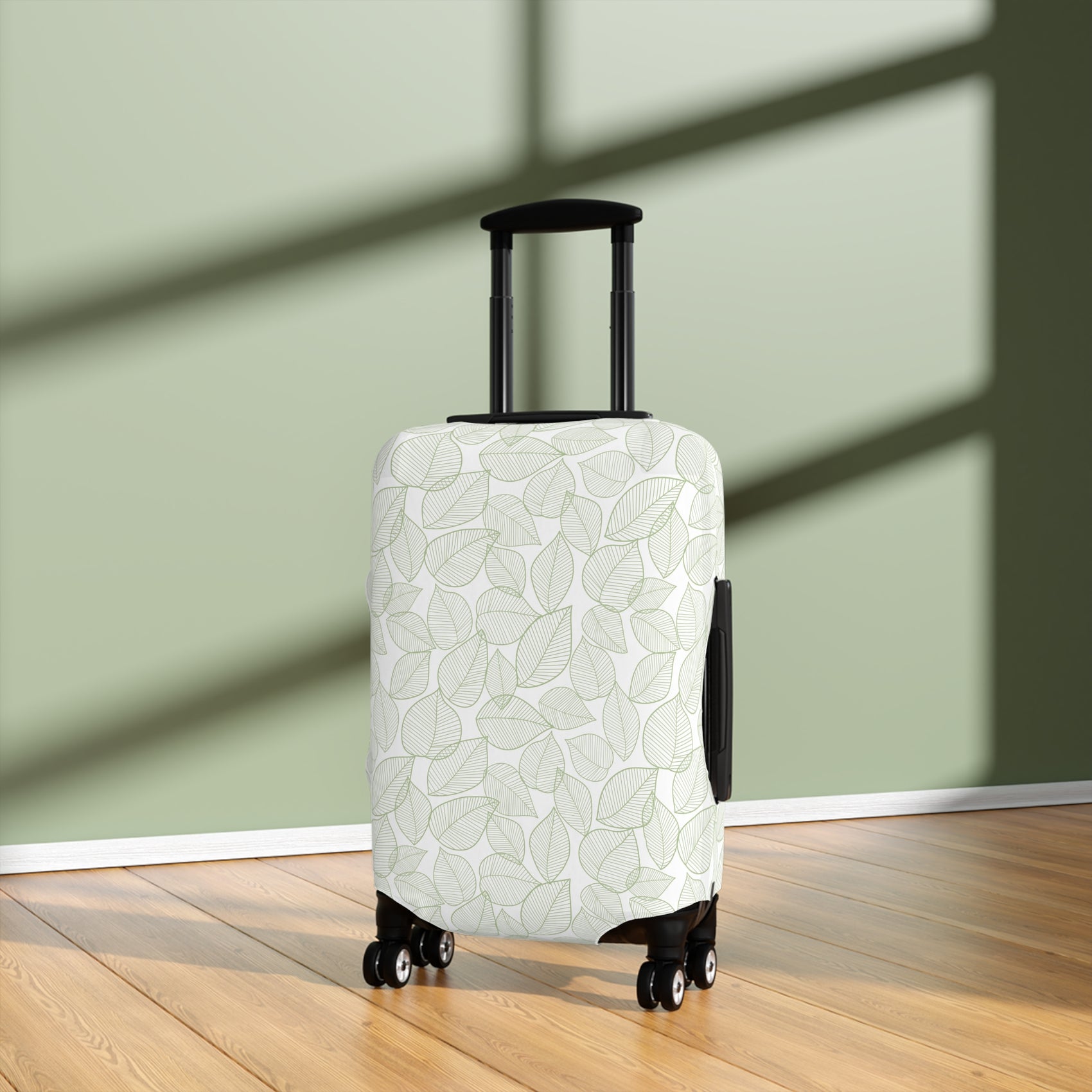 Urban Botanica stretch luggage cover with minimalist green leaf pattern on white background