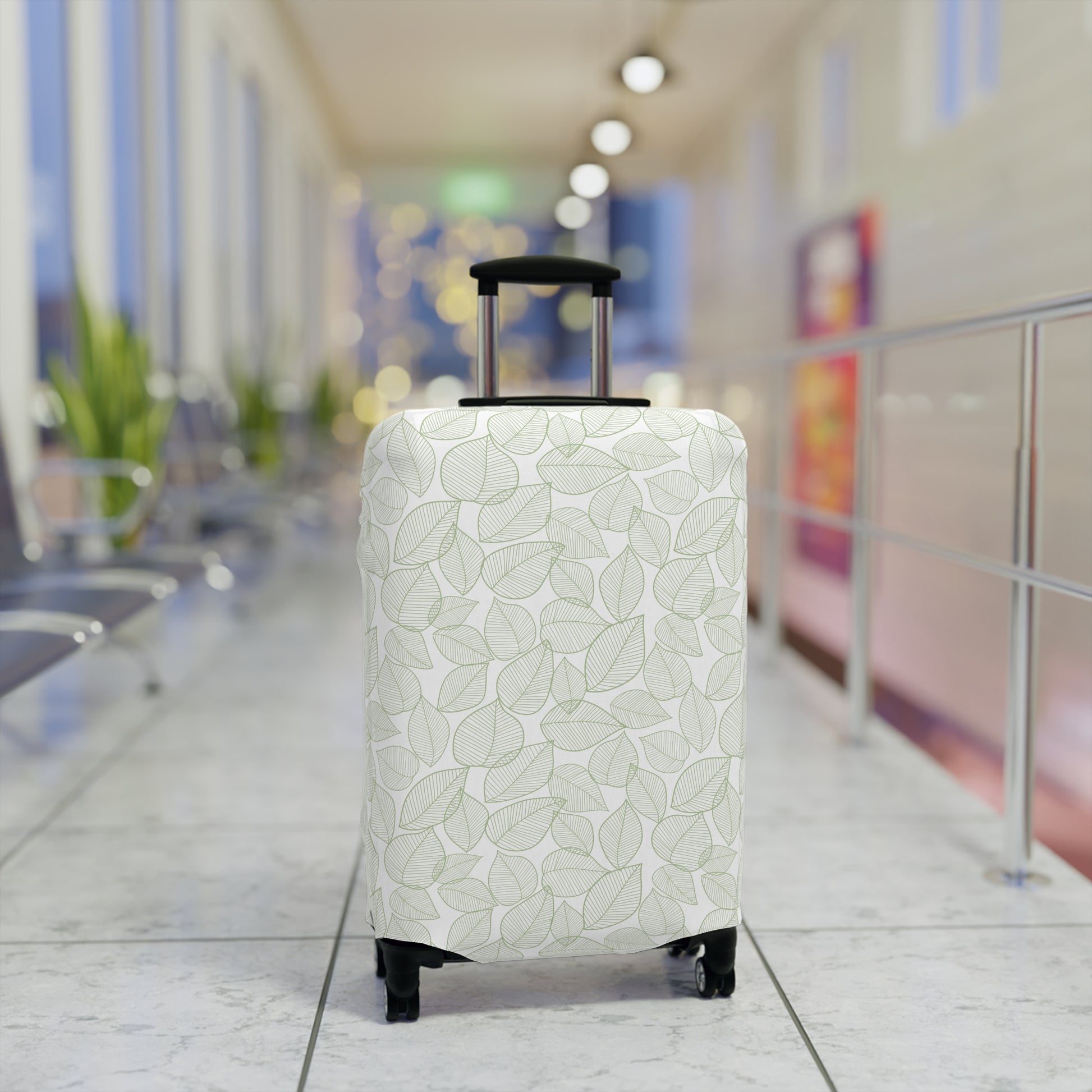 Urban Botanica stretch luggage cover with minimalist green leaf pattern on white background