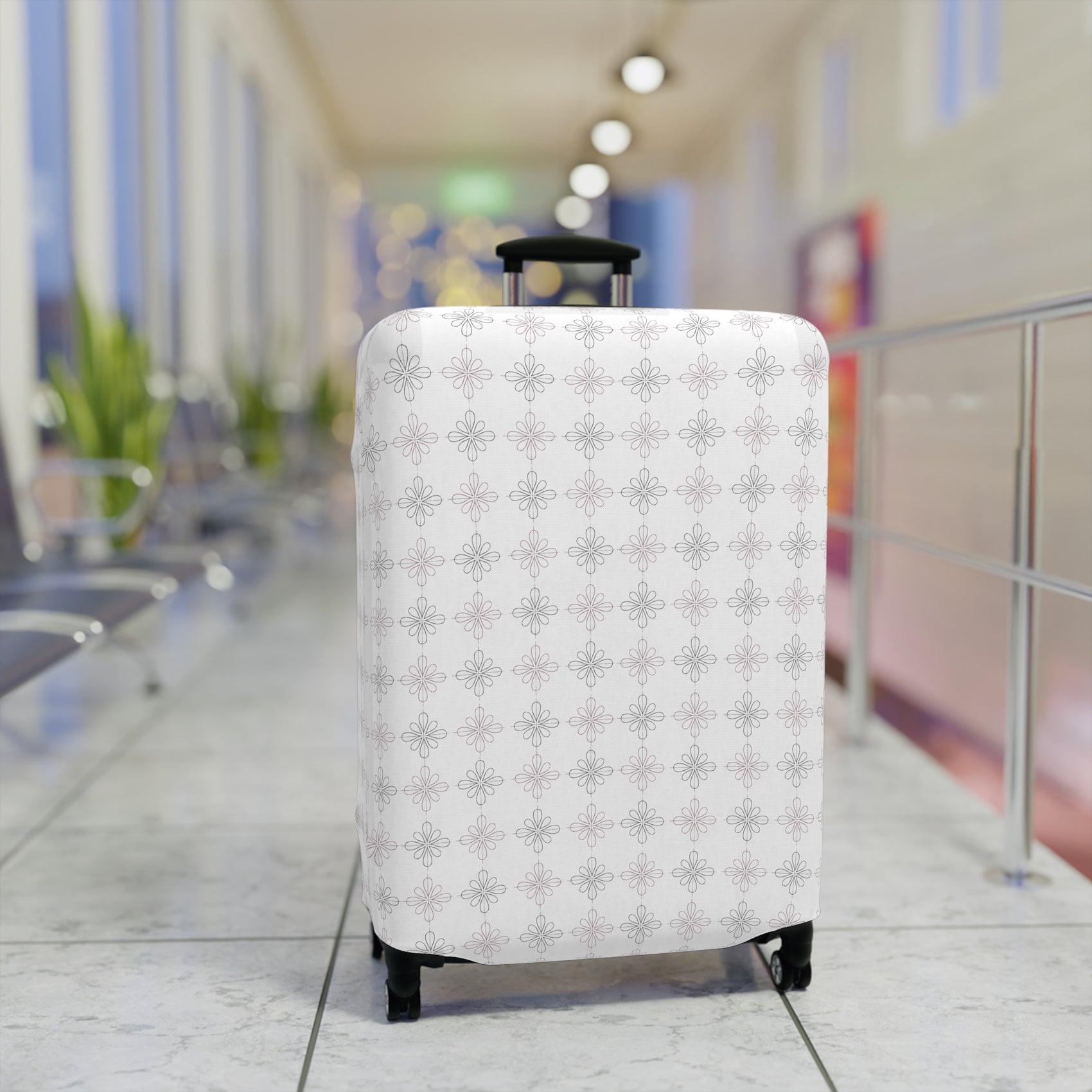 White floral minimalist stretch luggage cover protecting a rolling suitcase