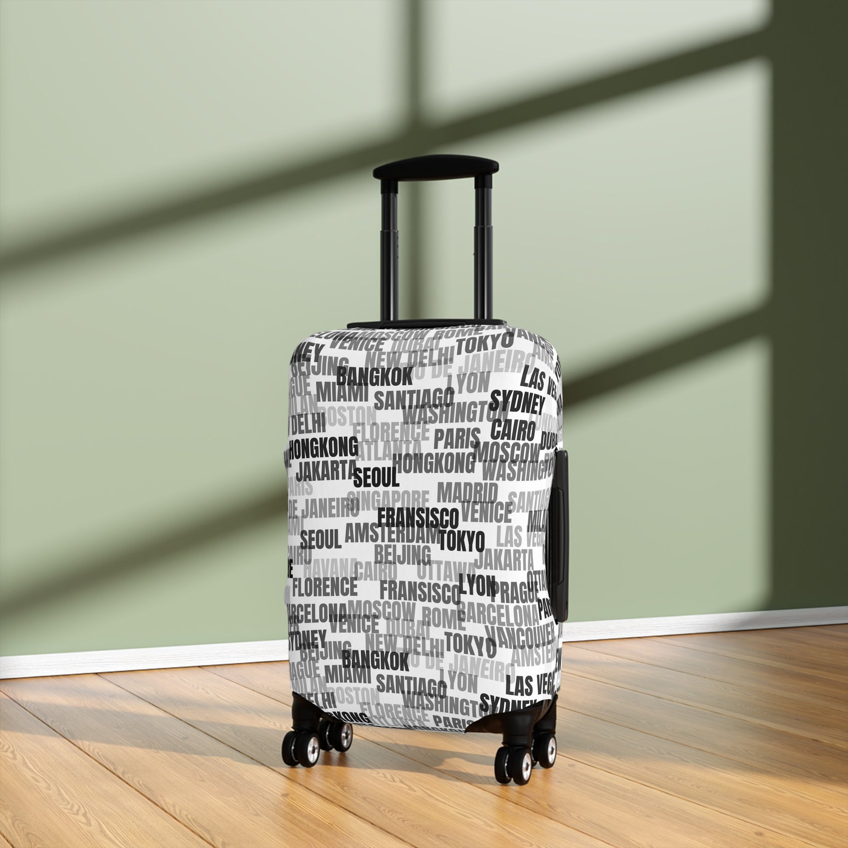 World in Motion white luggage cover with black city name typography fitted on rolling suitcase