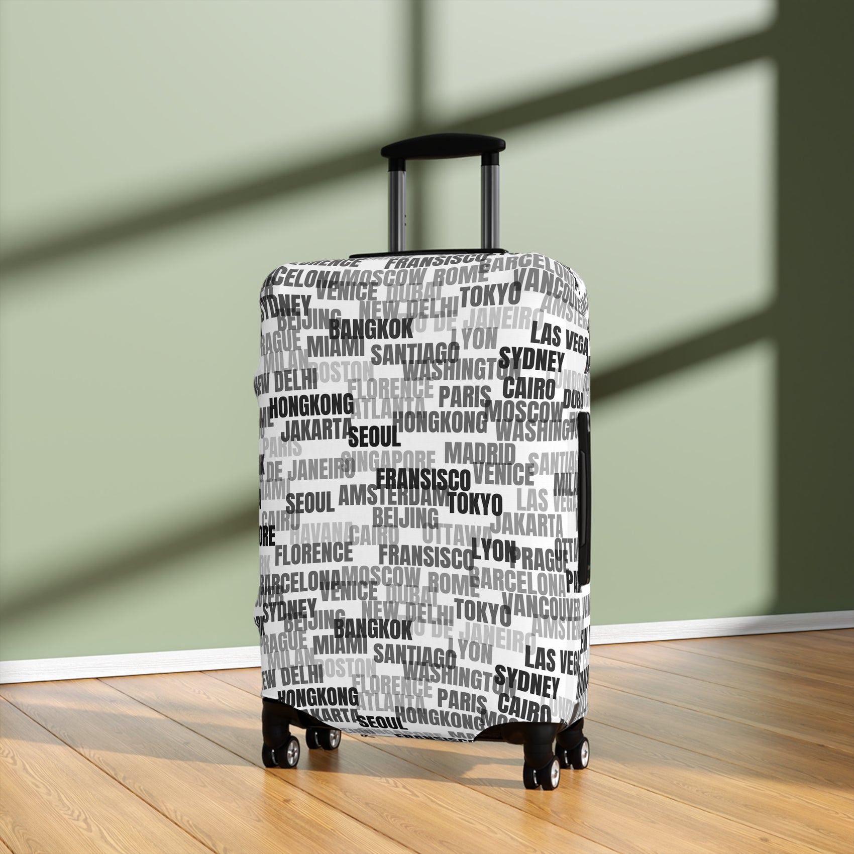World in Motion white luggage cover with black city name typography fitted on rolling suitcase