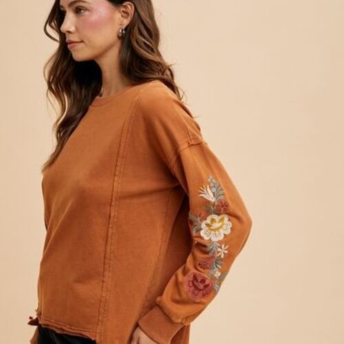 Embroidered Long Sleeve French Terry Top - Front View Cozy and Stylish Cotton Pullover with High-Low Hem Elegant Embroidery Detail on Soft French Terry Fabric Exposed Seam and Ribbed Accents on Casual Pullover Long Sleeve French Terry Sweatshirt Styled for Everyday Wear