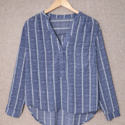 Blue Striped V-Neck Blouse - Front View Elegant Button-Down Blouse for Work & Travel Wear Soft & Lightweight Striped Long Sleeve Shirt for Jet Setters Business Casual Blouse Styled with Trousers for Travel Days Classic Striped Shirt with Pockets & Button Details - Perfect for Exploring