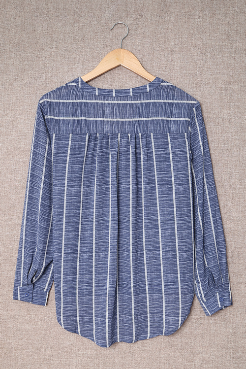 Blue Striped V-Neck Blouse - Front View Elegant Button-Down Blouse for Work & Travel Wear Soft & Lightweight Striped Long Sleeve Shirt for Jet Setters Business Casual Blouse Styled with Trousers for Travel Days Classic Striped Shirt with Pockets & Button Details - Perfect for Exploring