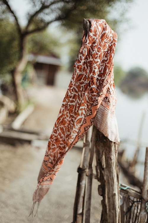 Hand-Dyed Cotton Scarf Naturally Dyed with Avocado and Madder Eco-Friendly Lightweight Cotton Scarf Draped Over Shoulders Soft Cotton Scarf in Earthy Tones with Natural Dye Variations Ethically Made Handwoven Scarf Styled as a Headwrap USA-Made Sustainable Fashion Scarf in Soft Cotton