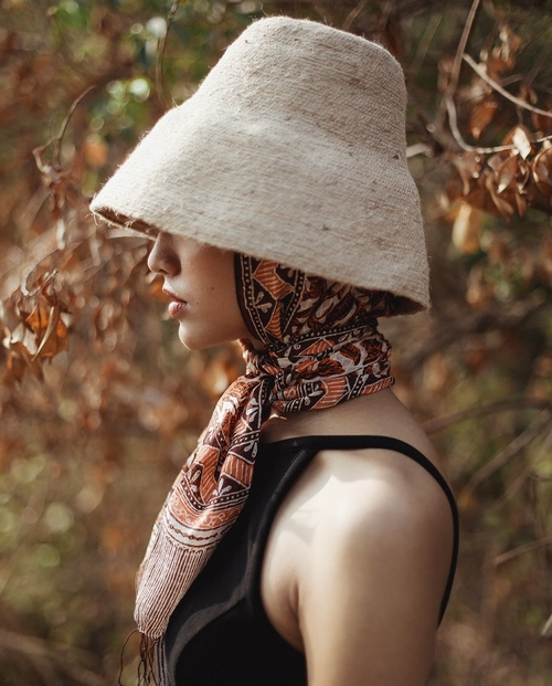 Hand-Dyed Cotton Scarf Naturally Dyed with Avocado and Madder Eco-Friendly Lightweight Cotton Scarf Draped Over Shoulders Soft Cotton Scarf in Earthy Tones with Natural Dye Variations Ethically Made Handwoven Scarf Styled as a Headwrap USA-Made Sustainable Fashion Scarf in Soft Cotton
